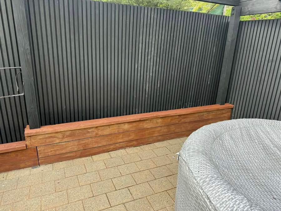 Composite fencing beside a garden planter box