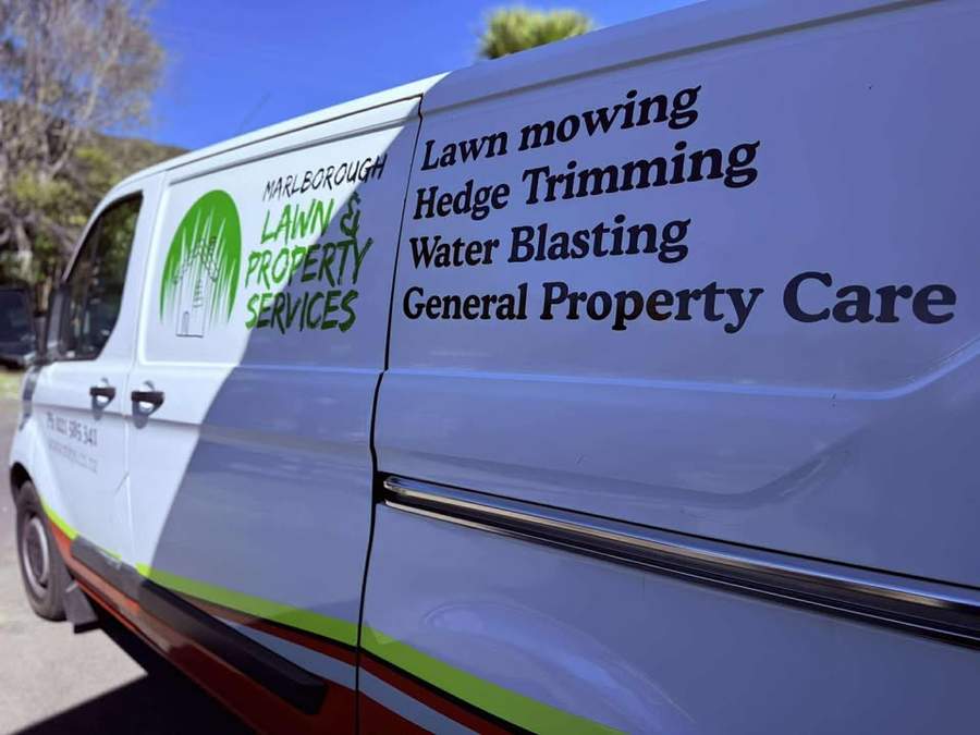 Van signage listing lawn mowing, hedge trimming, water blasting and general property care